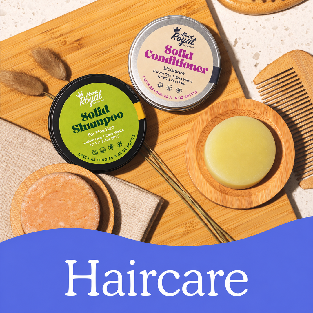 Mount Royal shampoo and conditioner tins with naked bars arranged on a bamboo board.