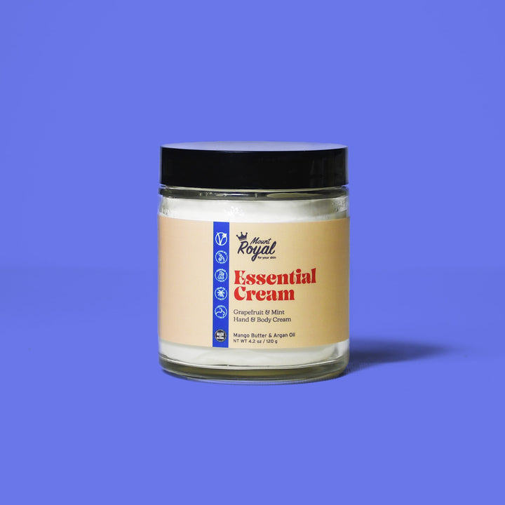 Essential Cream jar on a blue background