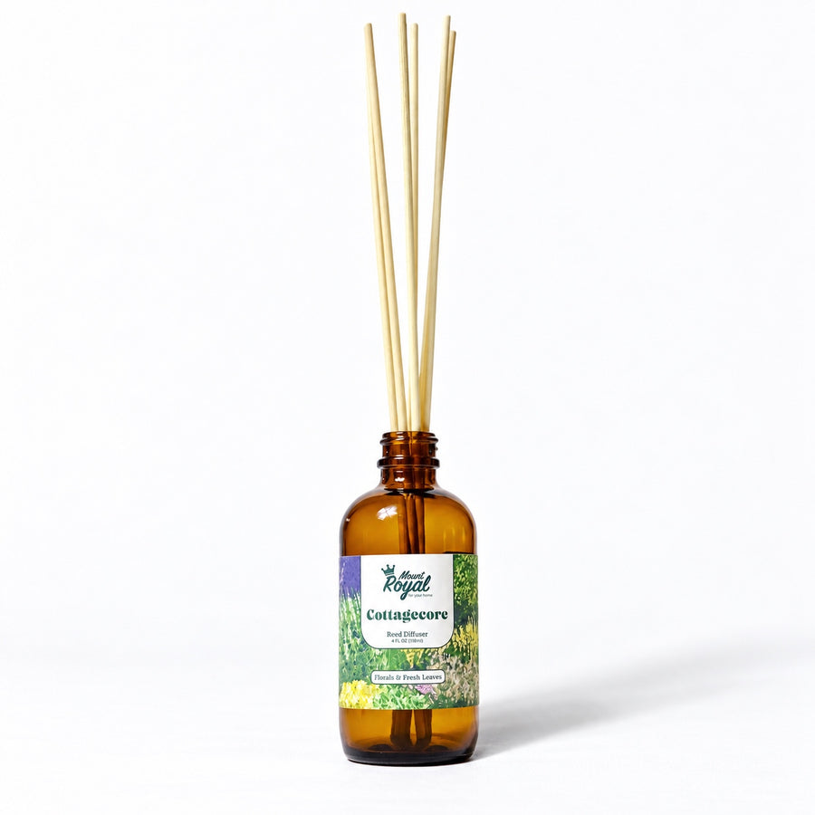 Cottagecore Reed Diffuser in an amber glass bottle with reeds on a white background