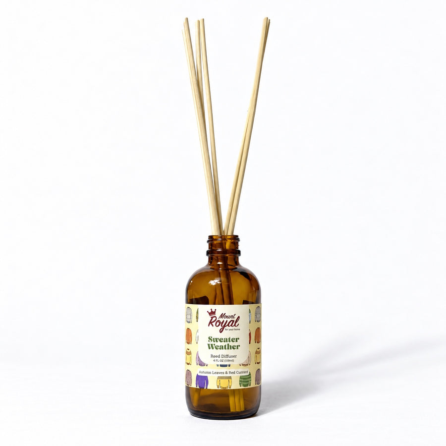 Sweater Weather Reed Diffuser in an amber glass bottle with reeds on a white background