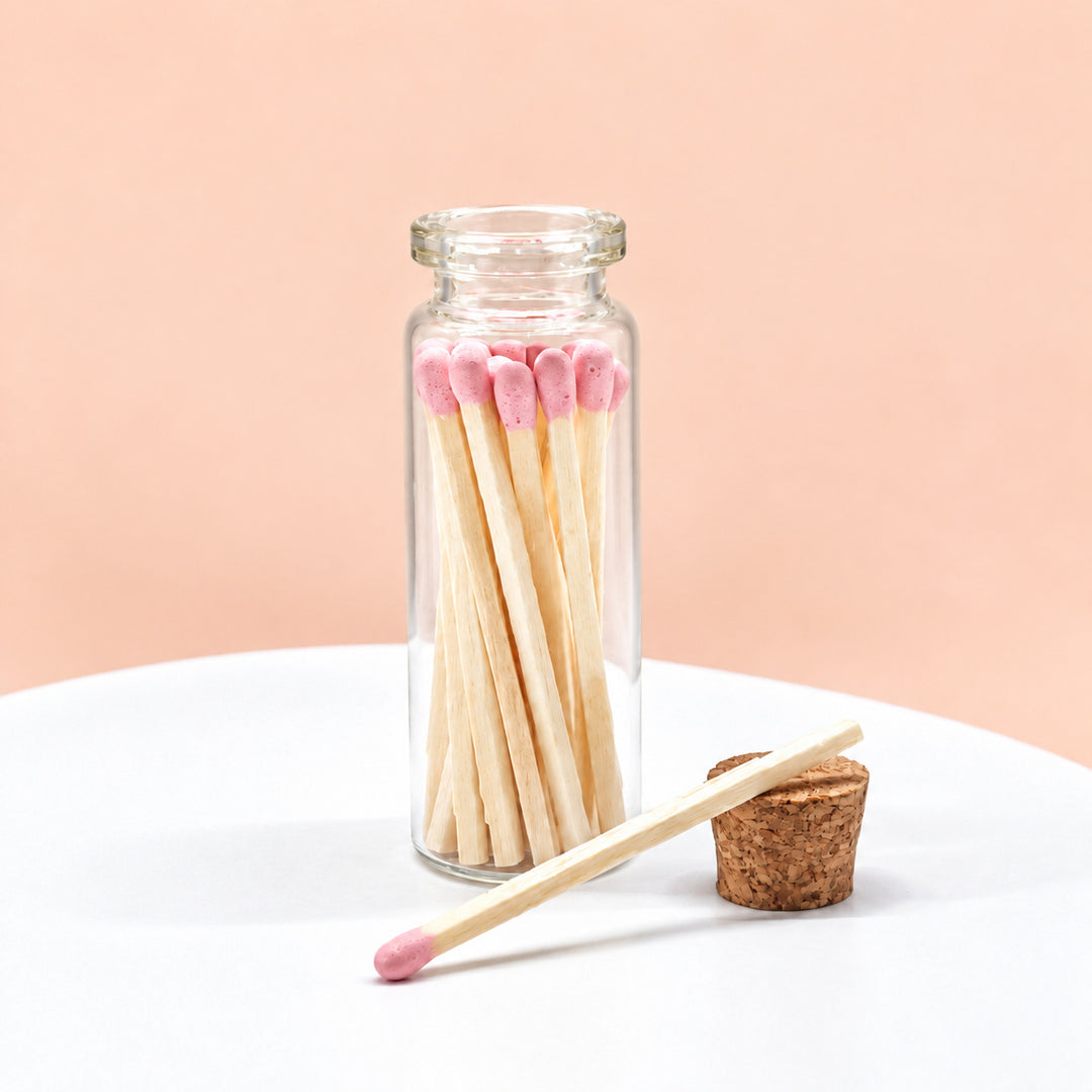 Baby Pink matches in a glass jar on a peach background