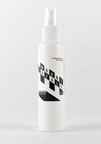 Checker patterned 4 ounce hand sanitizer spray bottle.
