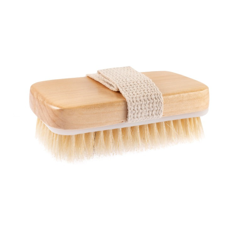 Wooden brush with a strap and golden bristles.